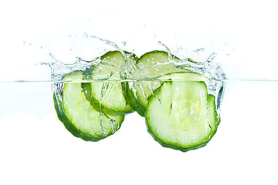 Cucumbers splashing into water