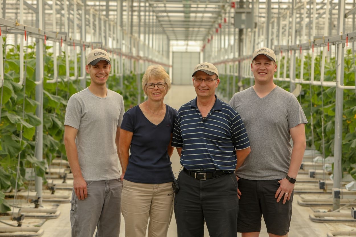 2 Generations of the Voorberg Family in the greenhouse.